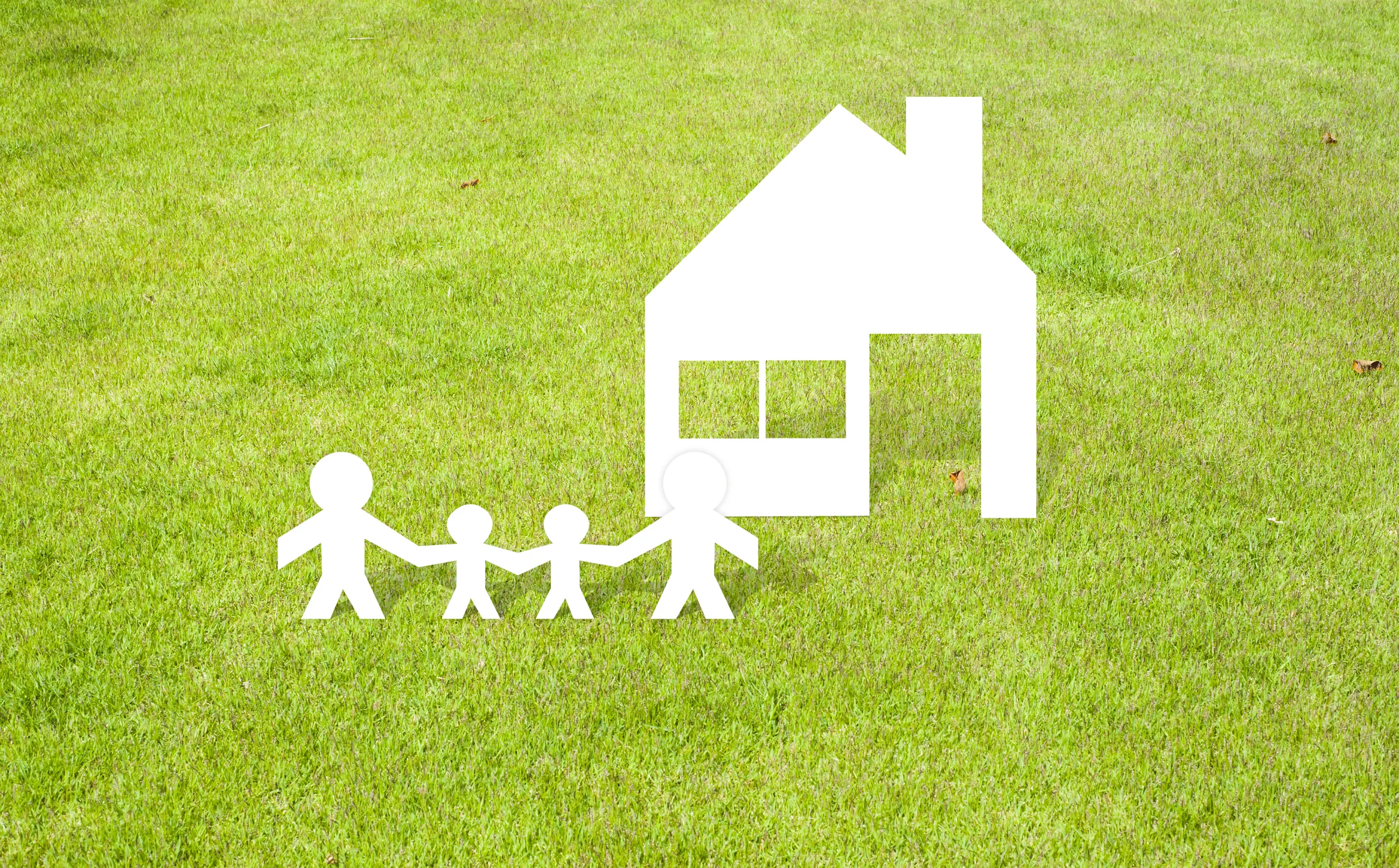 Family Home Of Paper Cut On Grass Background